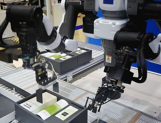 Robot arms working at an assembly line