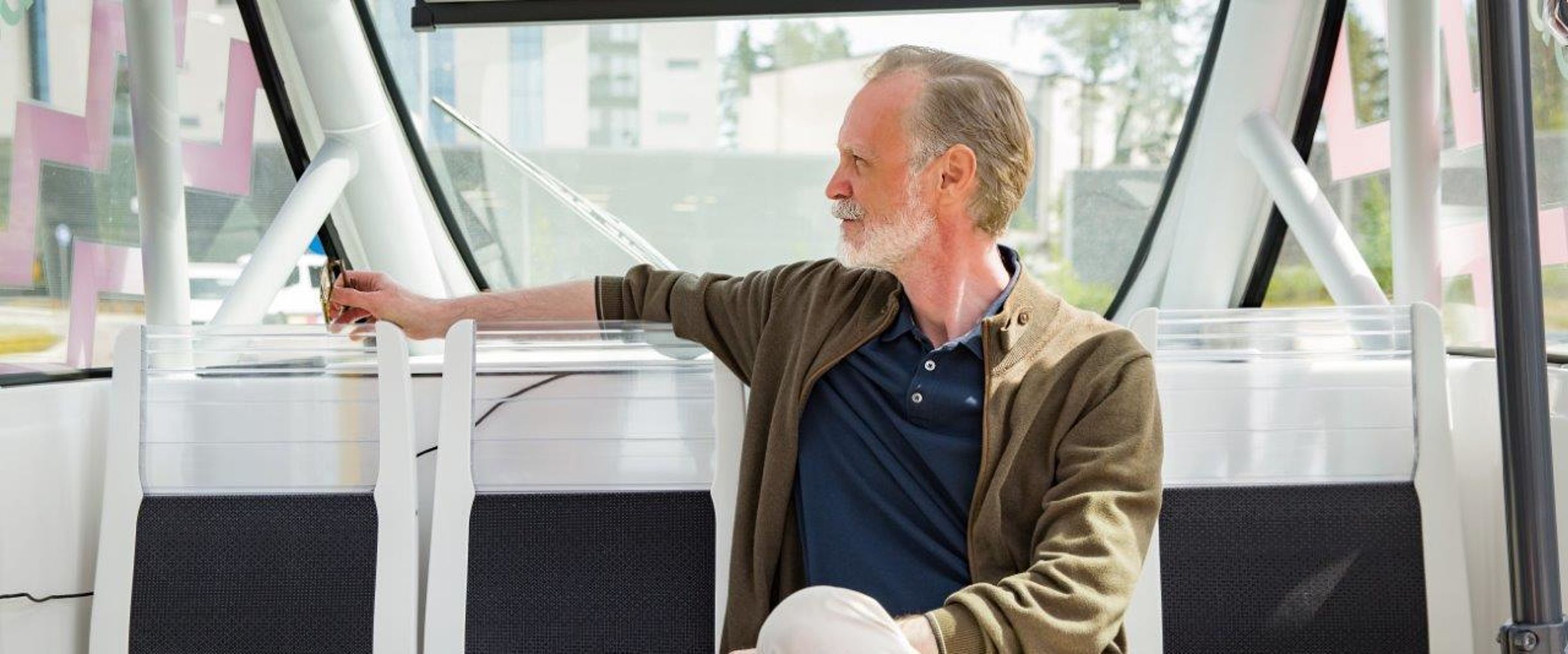 elderly gentleman sitting in a self-propelled bus