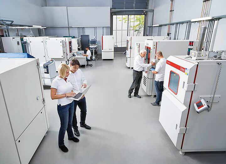 scientists standing in a hall and talking to another