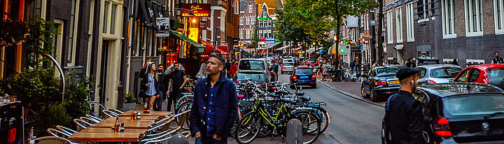 Street with pedestrians and moving cars