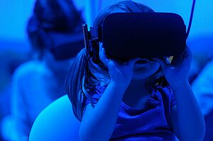Child wearing a VR set. Photo by Giu Vicente on Unsplash