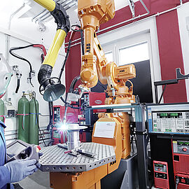 scientist using a machine in the additive manufacturing laboratory